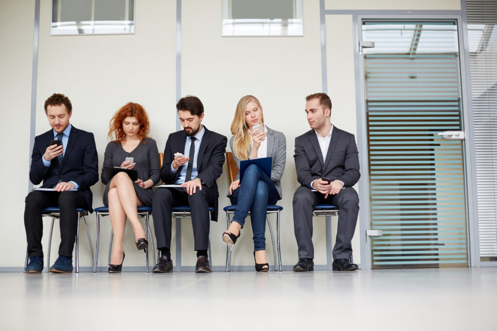 Applicants sitting and waiting for their job interview.