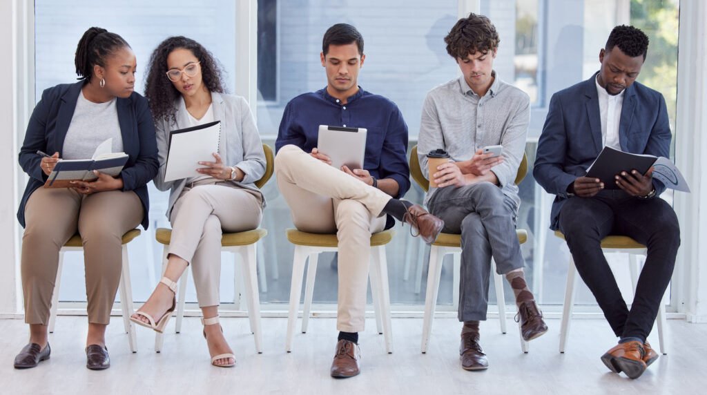 Job applicants waiting in line for an entry-level job interview.